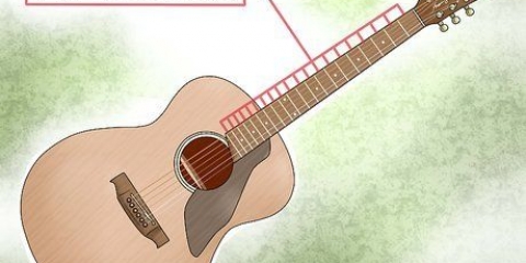 Spiller skalaer på en guitar